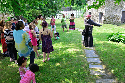 Philadelphia, PA, USA - June 12, 2013; The history of Harriet Tubman is shared by re-enactor Millicent Sparks in the garden of John Johnson House, a historic Underground Railroad location, during the annual Juneteenth day in the Germantown section of Northwest Philadelphia, PA, USA on June 15, 2013. The Juneteenth Independence Day or Freedom Day commemorates the announcement of abolition of slavery on June 19, 1865.