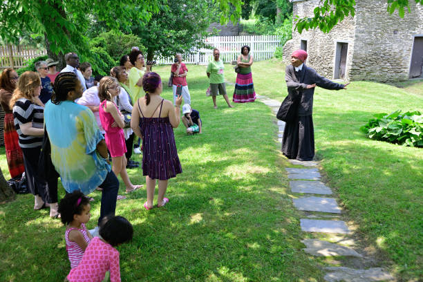 Philadelphia, PA, USA - June 12, 2013; The history of Harriet Tubman is shared by re-enactor Millicent Sparks in the garden of John Johnson House, a historic Underground Railroad location, during the annual Juneteenth day in the Germantown section of Northwest Philadelphia, PA, USA on June 15, 2013. The Juneteenth Independence Day or Freedom Day commemorates the announcement of abolition of slavery on June 19, 1865.