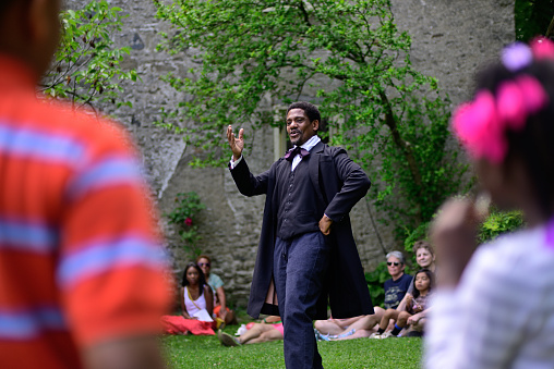 Philadelphia, PA, USA - June 12, 2013; Members of the community listen as a re-enactor share the story of how Henry \