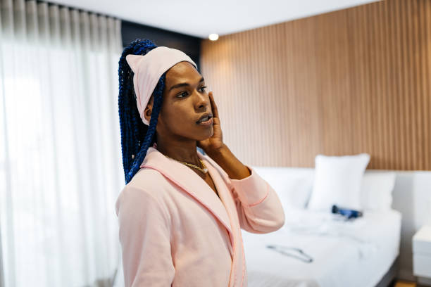 istock Trans woman in pink bathrobe in bedroom 1324051859