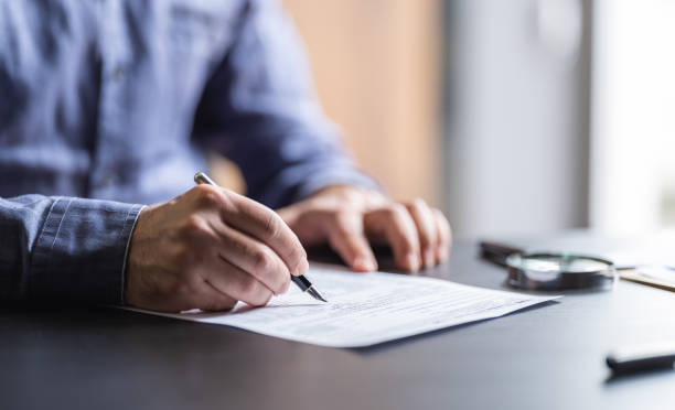 istock Man Filling In The Tax Form 1324054263