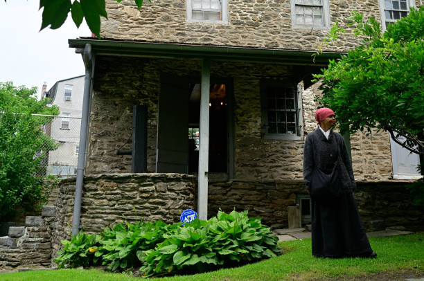 Philadelphia, PA, USA - June 20, 2015; The history of Harriet Tubman is shared by re-enactor Millicent Sparks in the garden of John Johnson House, a historic Underground Railroad location, during the annual Juneteenth day in the Germantown section of Northwest Philadelphia, PA, USA on June 20, 2015. The Juneteenth Independence Day or Freedom Day commemorates the announcement of abolition of slavery on June 19, 1865.