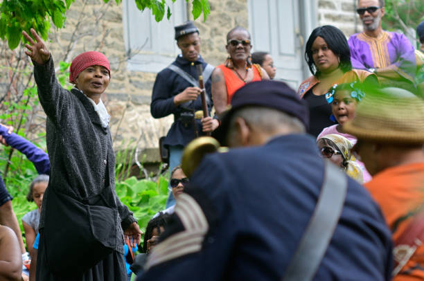 Philadelphia, PA, USA - June 20, 2015; The history of Harriet Tubman is shared by re-enactor Millicent Sparks in the garden of John Johnson House, a historic Underground Railroad location, during the annual Juneteenth day in the Germantown section of Northwest Philadelphia, PA, USA on June 20, 2015. The Juneteenth Independence Day or Freedom Day commemorates the announcement of abolition of slavery on June 19, 1865.