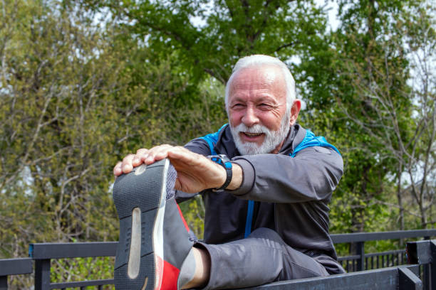 Senior man stretching legs in the park.