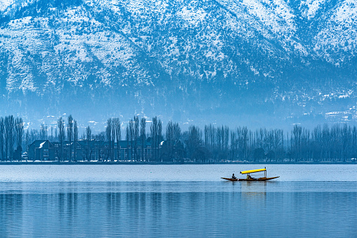 A view of Dal Lake in winter, and the beautiful mountain range in the background in the city of Srinagar, Kashmir, India.