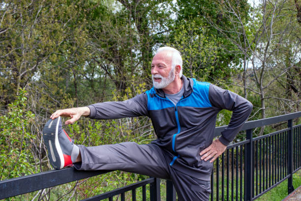 istock Senior man stretching legs in the park. 1324054532