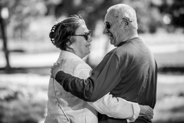 istock Senior adults walking in a park holding hands 1324055076