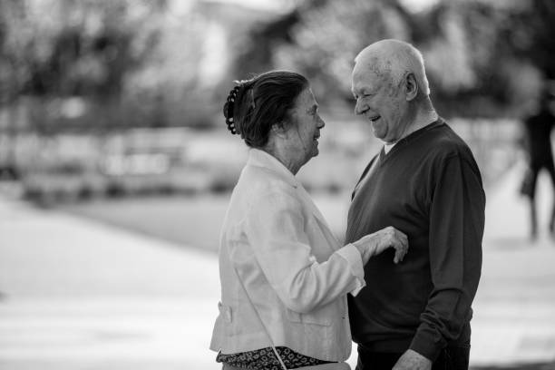 istock Senior adults walking in a park holding hands 1324055304