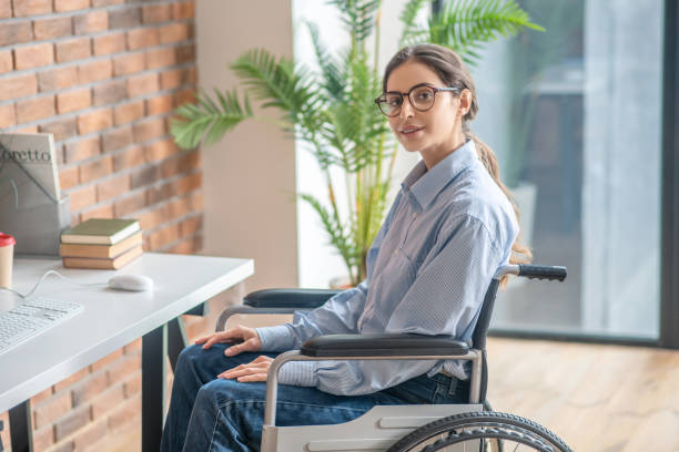 istock Young dark-haired handicapped woman looking thoughtful 1324062421