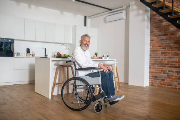istock Gray-haired mature handicapped man in the kicthen 1324062433