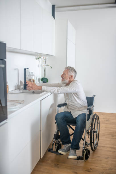 istock Mature handicapped man at home doing some housework 1324062449