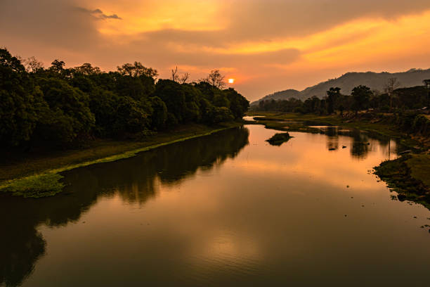istock sunrise dramatic sky at dawn with leading river water flow and forest trails 1324063014