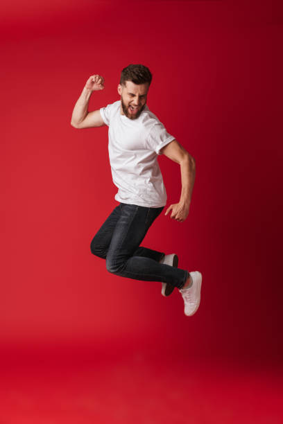 istock Handsome young man jumping showing winner gesture. 1324063118