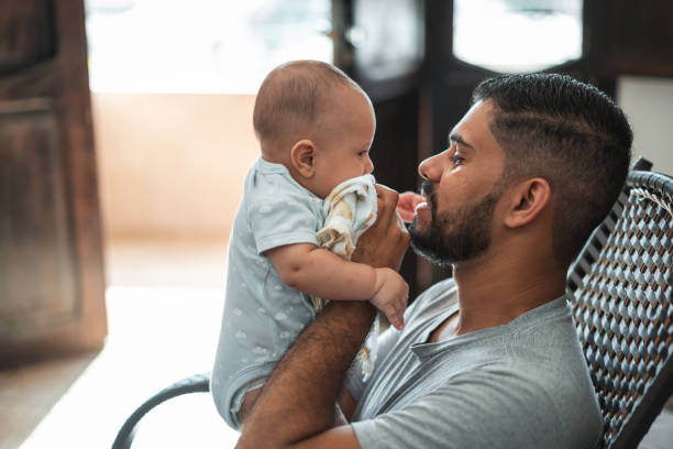 istock Father cleaning mouth son baby 1324063310