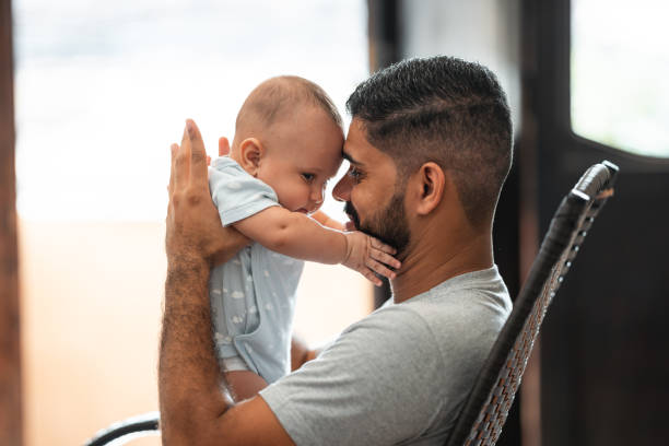 istock Real life father holding baby son 1324063344