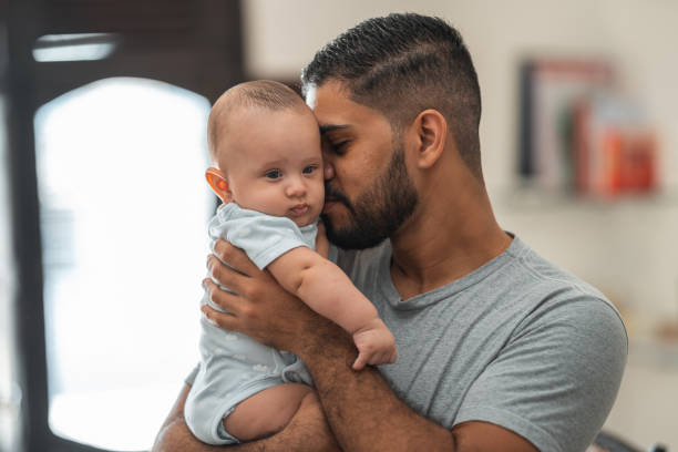 istock Father holding baby son 1324063348