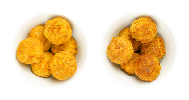 Vegan falafel balls, pre- and deep-fried chickpea fritters, in white bowls