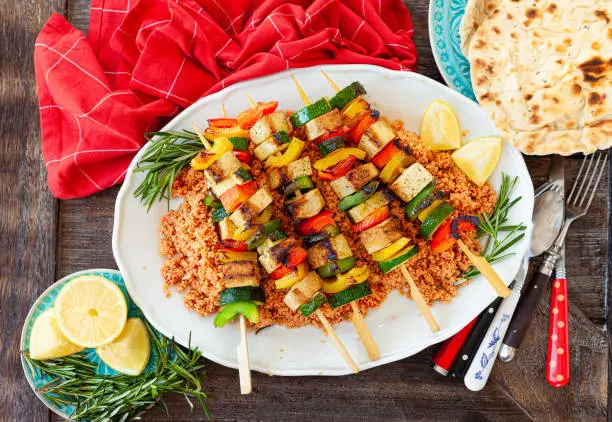 Grilled vegetable skewers with soy on tomato couscous