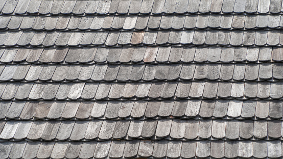 Tropical shingle layer on roof, natural pattern house or cottage. Texture background. Nature material.