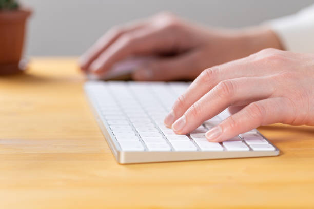 istock Office worker checks email while sitting at a wooden table. 1324067592