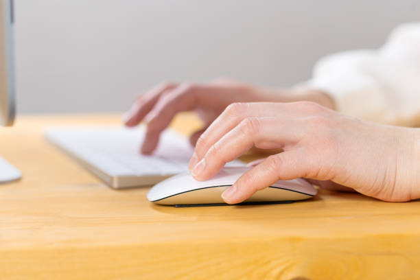 istock Close-up of young female hands pressing keyboard buttons and using a mouse. work from home. office. shopping 1324067692