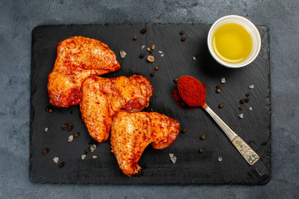 istock Hot chicken wings on black background 1324067784