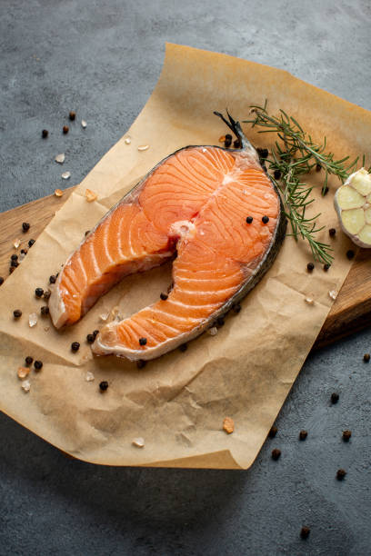 istock Salmon fish steak on black background 1324067804