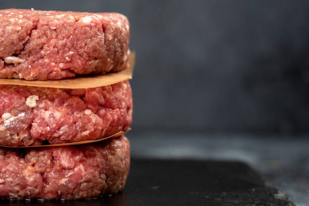 istock Minced beef meat for burger on black background 1324068124