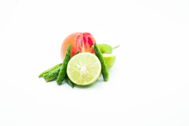 istock Fresh citrus and tomato green chhili together on white background 1324068909