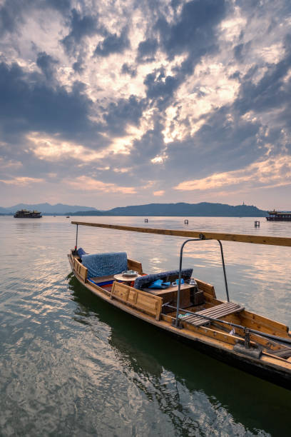 istock Rowing boat under the magic sky, West Lake, Hangzhou, China 1324069080