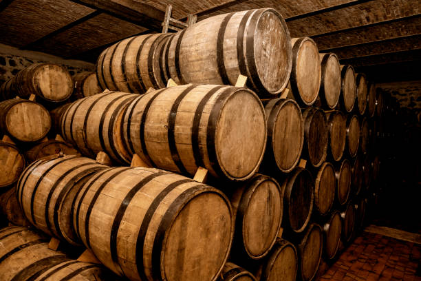 istock Wine barrels stacked in the old cellar. 1324069359