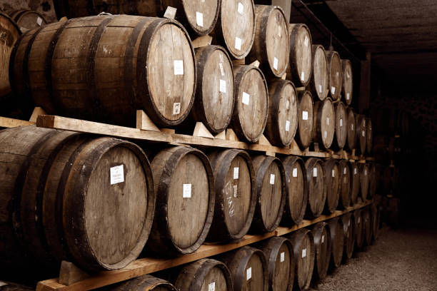 istock Wine barrels stacked in the old cellar. 1324070495
