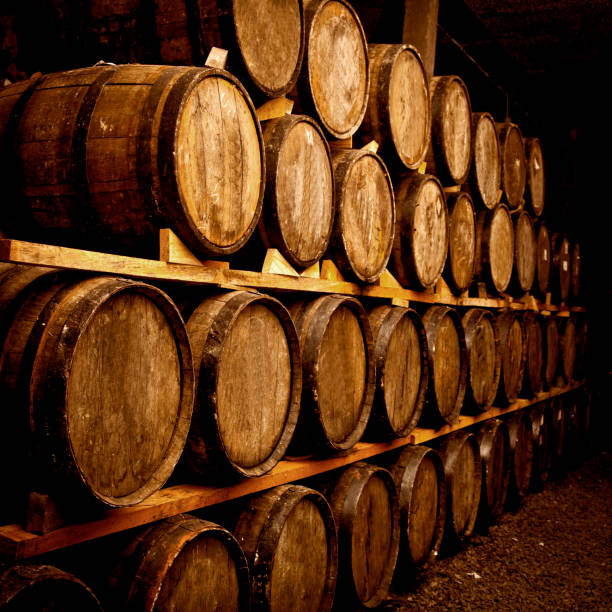 istock Wine barrels stacked in the old cellar. 1324070500