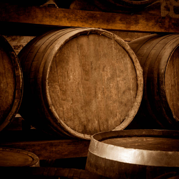 istock Wine barrels stacked in the old cellar. 1324070618