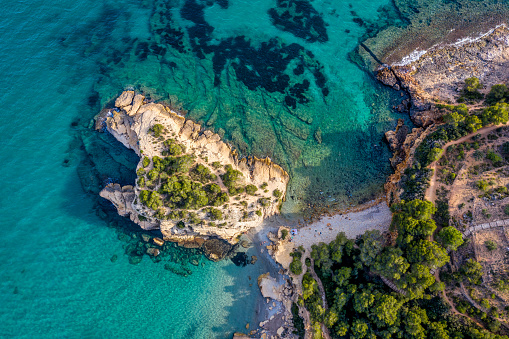 Aerial view of Roca de l'Illot rock island and beach, in l'Amettla de Mar, Costa Dorada, Catalonia, Spain