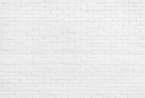 White brick wall, sunlit background. Light painted stone texture for design templates or web backdrop.
