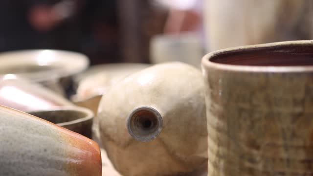 Shallow Focus Pan Over Pots and Clay Creations from Traditional Kiln