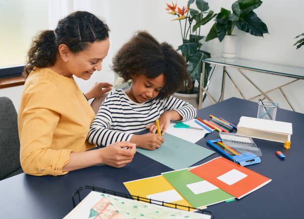 African American girl with autistic disorder with child's psychologist while psychological treatments for kid African American girl with autistic disorder with child's psychologist while psychological treatments for kid sad african child drawings stock pictures, royalty-free photos & images