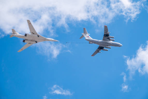 The group of supersonic strategic bomber of long-range aviation Tu-160 and flying tanker Il-78m fly over the Red Square Moscow, Russia - May, 05, 2021: The group of supersonic strategic bomber of long-range aviation Tu-160 and flying tanker Il-78m fly over the Red Square. Tu-160 and IL-78M in the skies over Moscow tu160 stock pictures, royalty-free photos & images