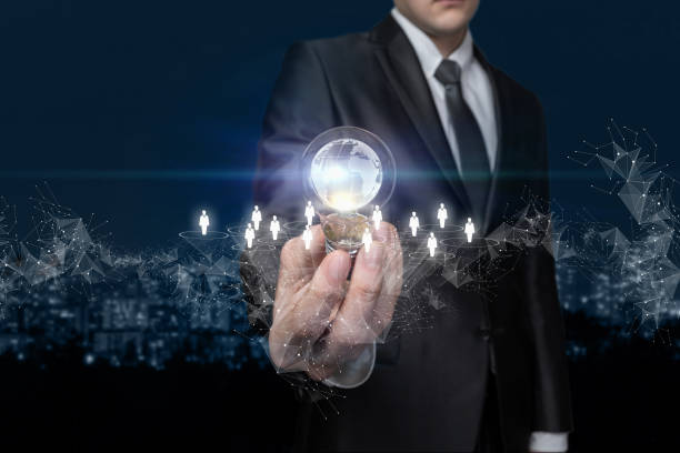 istock Businessman shows a light bulb in which the global network is located. 1324083254