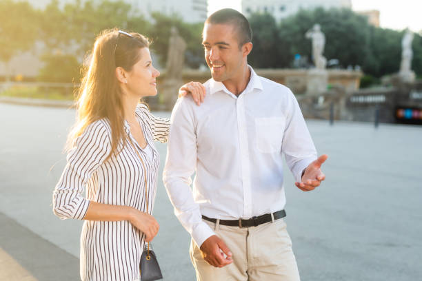 istock Young couple strolling through sunny city streets 1324084506