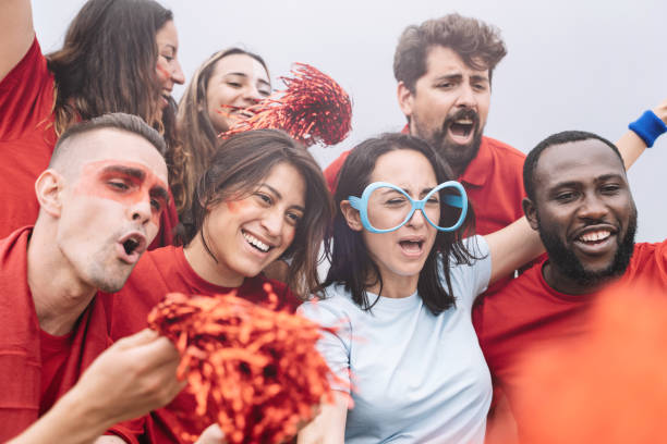 istock Multi ethnic football supporters singing and supporting their team before the competition or match 1324087879