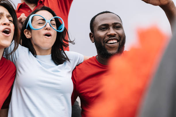 istock Multi ethnic couple cheering at live soccer match supporting their team 1324087889