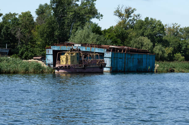 istock abandoned rusty ship on the river bank. 1324088081