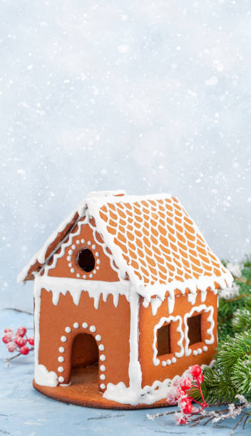 istock Christmas greeting card with gingerbread house and fir tree 1324089176