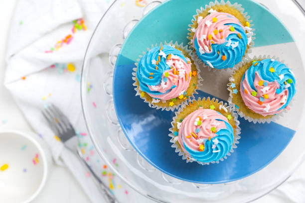 istock Bright and colorful blue and pink cupcakes with sprinkles 1324089471