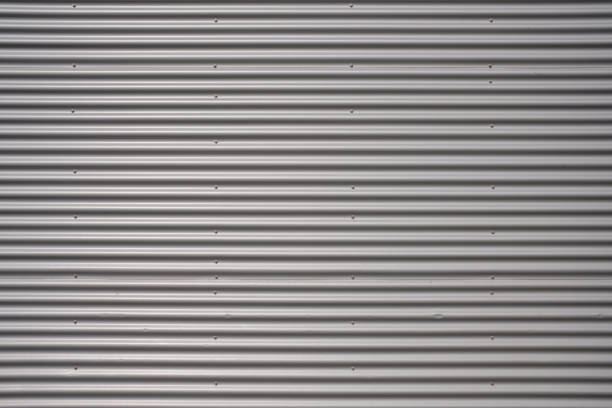 istock Texture of a silver corrugated sheet metal aluminum facade. 1324091867