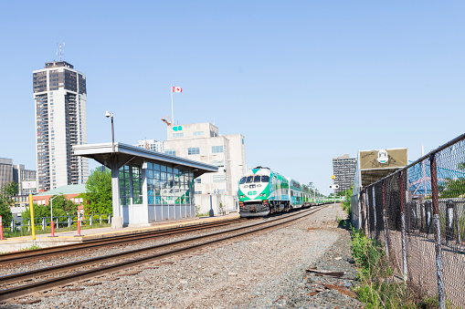 HAMILTON, Ontario, Canada - June 2021: Go Transit train is parked on the railway at the Go Transit train station in downtown Hamilton.