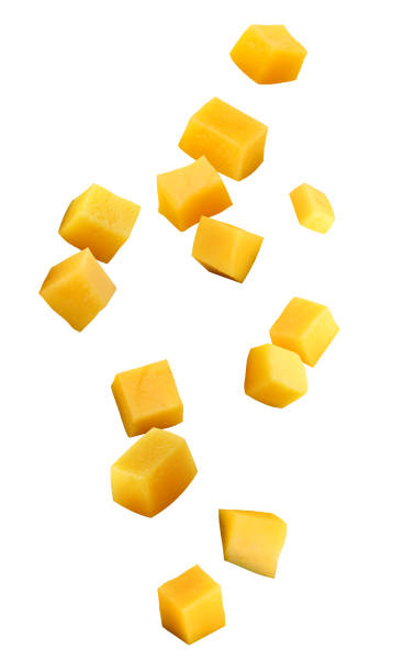 falling mango chunks isolated on a white background falling mango chunks  isolated on a white background with a clipping path. piece of mango in the air. mango stock pictures, royalty-free photos & images