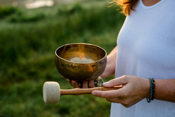 istock Close up - woman holds singing bowl in her hand 1324094418